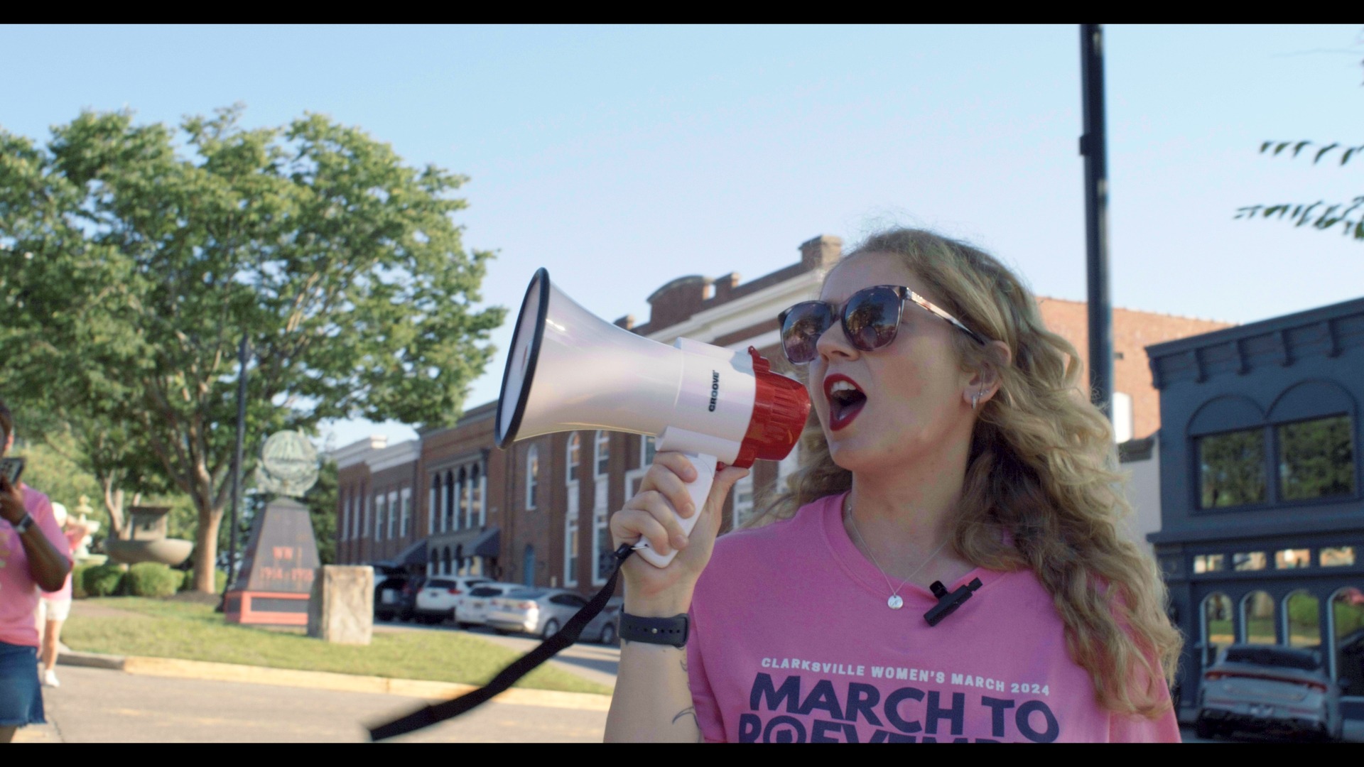 Allie marching with a bullhorn