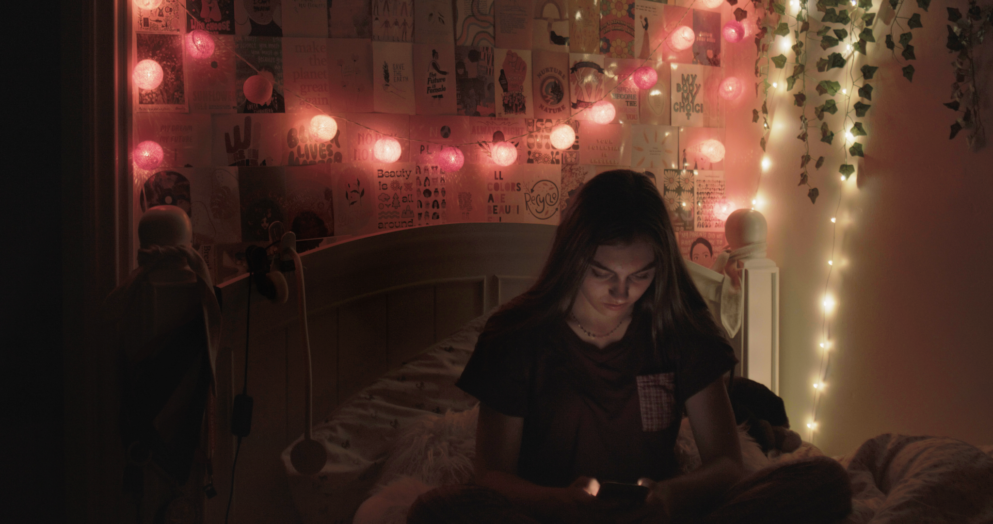 Soraya in her bedroom beneath string lights